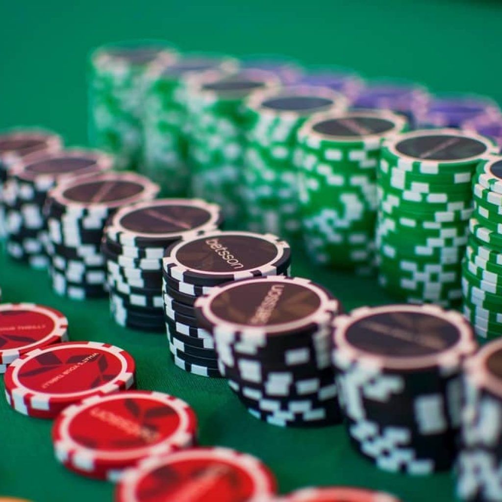 Poker chips on a poker table illustrating pot commitment and over-folding strategy