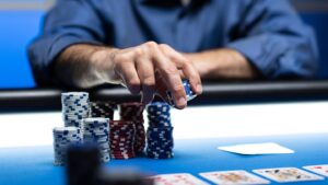 Poker player placing chips into the pot at a live poker table