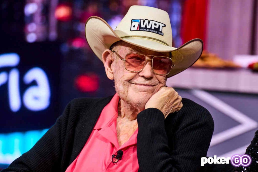Poker legend Doyle Brunson sitting at a poker table during a live game.