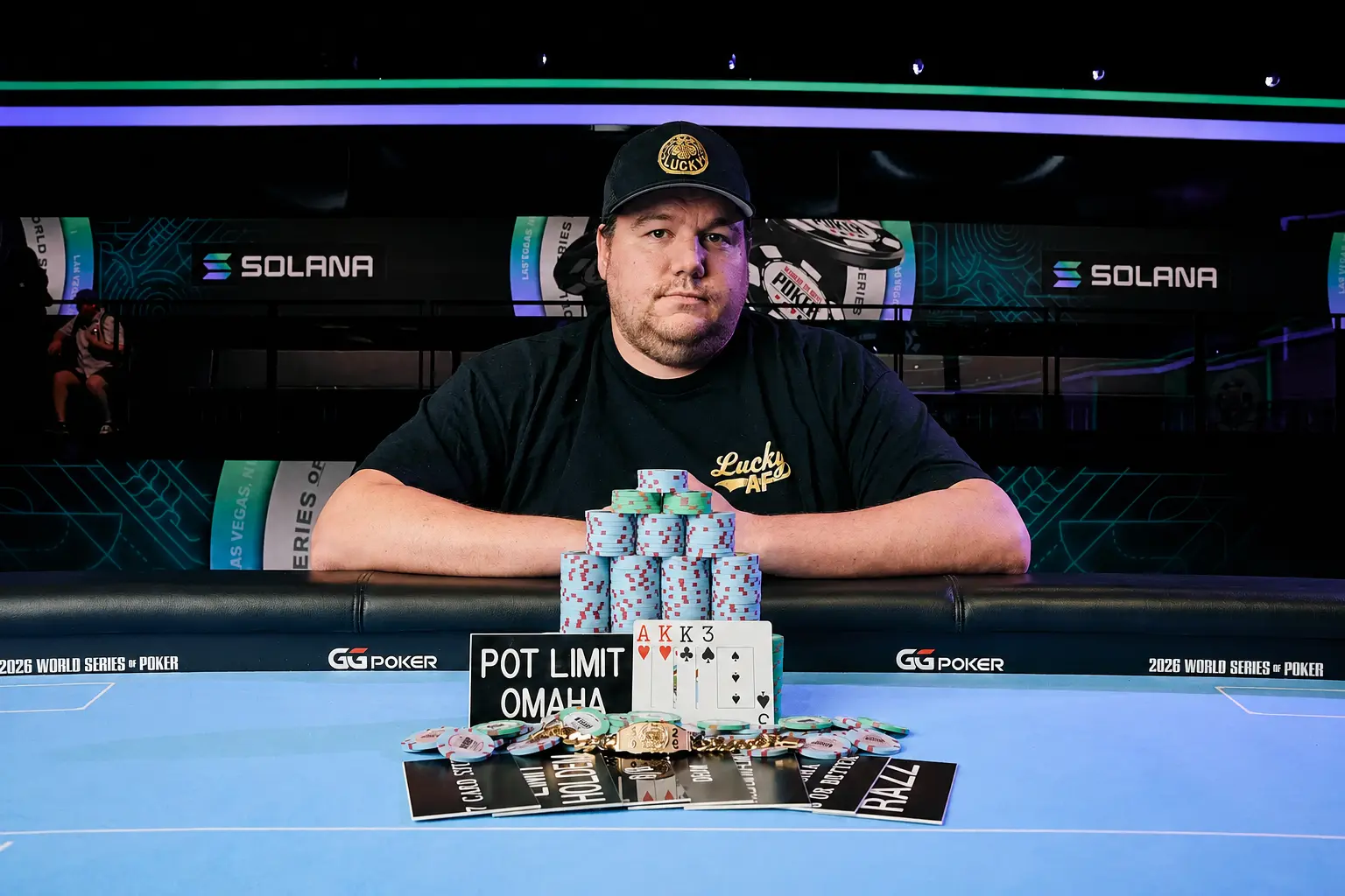Professional poker player Shaun Deeb posing with a stack of chips, a winning Pot Limit Omaha hand, and a gold bracelet at the 2026 World Series of Poker