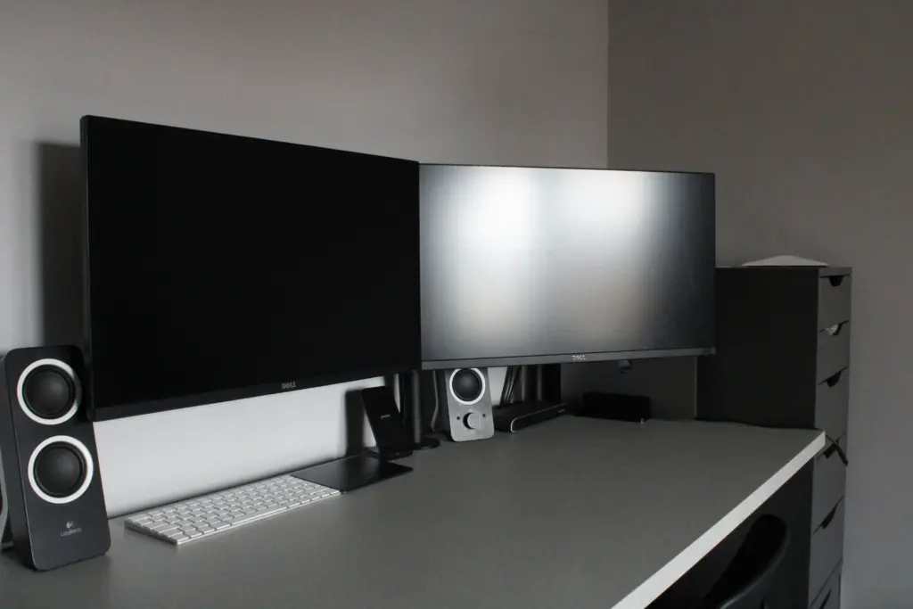 A professional two-monitor computer setup on a desk, ideal for multi-tabling online poker.
